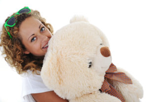 Teenage girl holding a teddy bear